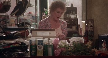 Movie still from “Come Back to the 5 & Dime Jimmy Dean, Jimmy Dean” (1982), directed by Robert Altman – A woman in a flower shop looking at a box of flowers; Medium shot, Over the shoulder angle