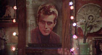 Movie still from “Come Back to the 5 & Dime Jimmy Dean, Jimmy Dean” (1982), directed by Robert Altman – A portrait of a young man is hanging on the wall; Close Up shot, Over the shoulder angle