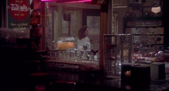 Movie still from “Come Back to the 5 & Dime Jimmy Dean, Jimmy Dean” (1982), directed by Robert Altman – A woman standing in front of a bar in front of a mirror; Wide shot, Over the shoulder angle