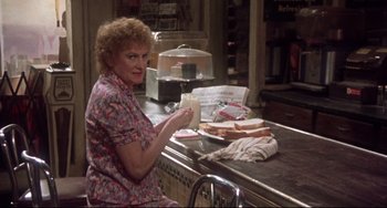 Movie still from “Come Back to the 5 & Dime Jimmy Dean, Jimmy Dean” (1982), directed by Robert Altman – An older woman sitting at a counter in a restaurant; Medium shot, High angle