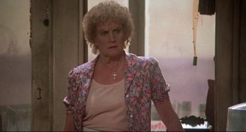 Movie still from “Come Back to the 5 & Dime Jimmy Dean, Jimmy Dean” (1982), directed by Robert Altman – An older woman wearing a pink shirt and a floral jacket; Close Up shot, Over the shoulder angle