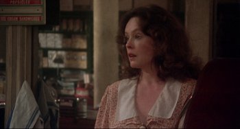 Movie still from “Come Back to the 5 & Dime Jimmy Dean, Jimmy Dean” (1982), directed by Robert Altman – A person with curly hair wearing a dress; Close Up shot, Over the shoulder angle