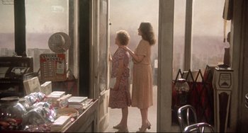 Movie still from “Come Back to the 5 & Dime Jimmy Dean, Jimmy Dean” (1982), directed by Robert Altman – Two women are standing in a doorway of a store; Wide shot, Over the shoulder angle