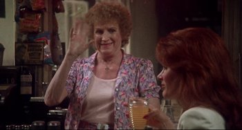 Movie still from “Come Back to the 5 & Dime Jimmy Dean, Jimmy Dean” (1982), directed by Robert Altman – Two women sitting at a table with a glass of orange juice in front of them; Medium shot, Over the shoulder angle