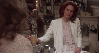 Movie still from “Come Back to the 5 & Dime Jimmy Dean, Jimmy Dean” (1982), directed by Robert Altman – A woman holding a glass of beer in her hand; Medium shot, Over the shoulder angle