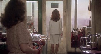 Movie still from “Come Back to the 5 & Dime Jimmy Dean, Jimmy Dean” (1982), directed by Robert Altman – A woman standing in front of a store window; Wide shot, Over the shoulder angle