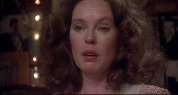 Movie still from “Come Back to the 5 & Dime Jimmy Dean, Jimmy Dean” (1982), directed by Robert Altman – A person with curly hair looking at the camera; Close Up shot, Over the shoulder angle