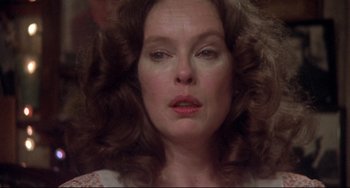 Movie still from “Come Back to the 5 & Dime Jimmy Dean, Jimmy Dean” (1982), directed by Robert Altman – A person with curly hair; Close Up shot, Over the shoulder angle