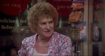 Movie still from “Come Back to the 5 & Dime Jimmy Dean, Jimmy Dean” (1982), directed by Robert Altman – An older woman in a floral jacket looking at the camera; Close Up shot, Over the shoulder angle