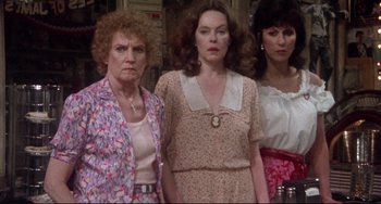 Movie still from “Come Back to the 5 & Dime Jimmy Dean, Jimmy Dean” (1982), directed by Robert Altman – A group of women standing next to each other in a room; Medium shot, Low angle