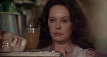 Movie still from “Come Back to the 5 & Dime Jimmy Dean, Jimmy Dean” (1982), directed by Robert Altman – A person sitting at a table with a drink; Close Up shot, Over the shoulder angle