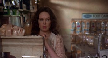Movie still from “Come Back to the 5 & Dime Jimmy Dean, Jimmy Dean” (1982), directed by Robert Altman – A woman standing in front of a counter; Medium shot, Over the shoulder angle