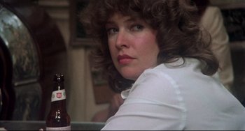 Movie still from “Come Back to the 5 & Dime Jimmy Dean, Jimmy Dean” (1982), directed by Robert Altman – A person holding a bottle of beer; Close Up shot, Over the shoulder angle