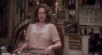 Movie still from “Come Back to the 5 & Dime Jimmy Dean, Jimmy Dean” (1982), directed by Robert Altman – A woman sitting at a table in front of pictures; Medium shot, Over the shoulder angle