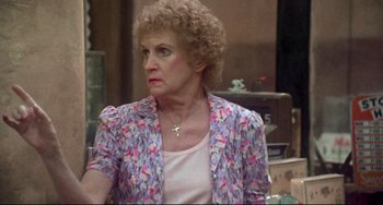 Movie still from “Come Back to the 5 & Dime Jimmy Dean, Jimmy Dean” (1982), directed by Robert Altman – An older woman wearing a pink and purple jacket; Close Up shot, Over the shoulder angle