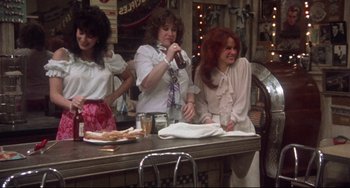 Movie still from “Come Back to the 5 & Dime Jimmy Dean, Jimmy Dean” (1982), directed by Robert Altman – A group of women sitting at a bar; Wide shot, High angle