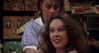 Movie still from “Come Back to the 5 & Dime Jimmy Dean, Jimmy Dean” (1982), directed by Robert Altman – A woman sitting next to another woman in a room; Close Up shot, Over the shoulder angle
