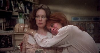 Movie still from “Come Back to the 5 & Dime Jimmy Dean, Jimmy Dean” (1982), directed by Robert Altman – Two women embracing each other in a store; Close Up shot, Low angle
