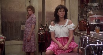 Movie still from “Come Back to the 5 & Dime Jimmy Dean, Jimmy Dean” (1982), directed by Robert Altman – Two women sitting on a bench in front of a window; Medium shot, Over the shoulder angle