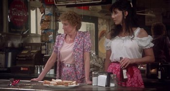 Movie still from “Come Back to the 5 & Dime Jimmy Dean, Jimmy Dean” (1982), directed by Robert Altman – Two women standing at a counter in front of sandwiches; Medium shot, Over the shoulder angle