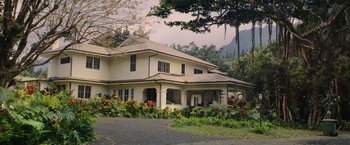 Movie still from “The Descendants” (2011), directed by Alexander Payne – A large white house surrounded by flowers and trees; Extreme Wide shot, High angle