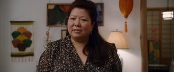 Movie still from “The Descendants” (2011), directed by Alexander Payne – A person with long hair wearing a shirt; Close Up shot, Over the shoulder angle