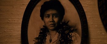 Movie still from “The Descendants” (2011), directed by Alexander Payne – An old photo of a woman wearing a necklace; Extreme Close Up shot, Low angle