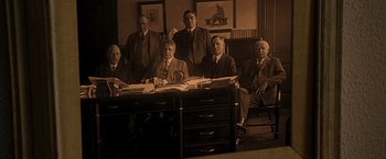 Movie still from “The Descendants” (2011), directed by Alexander Payne – A group of men sitting at a desk in a room; Wide shot, High angle