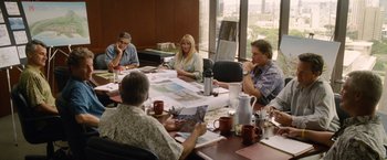 Movie still from “The Descendants” (2011), directed by Alexander Payne – A group of people sitting around a table with papers; Wide shot, High angle
