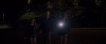 Movie still from “The Descendants” (2011), directed by Alexander Payne – A man and a woman and a little girl walking in the dark with a flashlight; Wide shot, Low angle