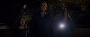 Movie still from “The Descendants” (2011), directed by Alexander Payne – A man standing next to a tree at night; Medium shot, Low angle