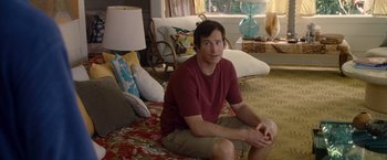 Movie still from “The Descendants” (2011), directed by Alexander Payne – A man sitting on a bed in a living room; Medium shot, High angle