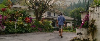 Movie still from “The Descendants” (2011), directed by Alexander Payne – A man walking down the street in front of a house; Wide shot, Low angle