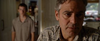 Movie still from “The Descendants” (2011), directed by Alexander Payne – A man's face in a room; Close Up shot, Over the shoulder angle
