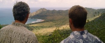 Movie still from “The Descendants” (2011), directed by Alexander Payne – A man looking out over a lush green hillside; Extreme Wide shot, Over the shoulder angle