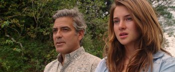 Movie still from “The Descendants” (2011), directed by Alexander Payne – A man and a woman standing next to each other in front of trees; Close Up shot, Over the shoulder angle