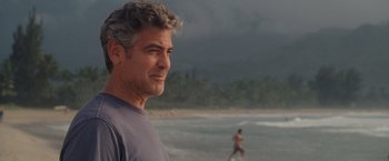 Movie still from “The Descendants” (2011), directed by Alexander Payne – A person on a beach near the ocean; Medium shot, Over the shoulder angle