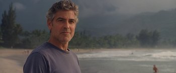 Movie still from “The Descendants” (2011), directed by Alexander Payne – A person standing near a body of water; Close Up shot, Over the shoulder angle