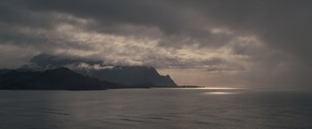 Movie still from “The Descendants” (2011), directed by Alexander Payne – A body of water under a cloudy gray sky; Extreme Wide shot, High angle
