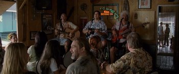 Movie still from “The Descendants” (2011), directed by Alexander Payne – A group of people sitting in a room with guitars; Wide shot, Over the shoulder angle