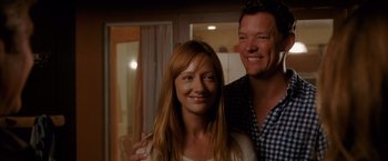 Movie still from “The Descendants” (2011), directed by Alexander Payne – A man and a woman smile for a picture; Close Up shot, Low angle