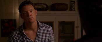 Movie still from “The Descendants” (2011), directed by Alexander Payne – A person wearing a plaid shirt; Close Up shot, Over the shoulder angle