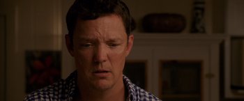 Movie still from “The Descendants” (2011), directed by Alexander Payne – A person with his eyes wide open; Close Up shot, Over the shoulder angle