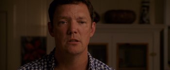 Movie still from “The Descendants” (2011), directed by Alexander Payne – A person wearing a checkered shirt; Close Up shot, Over the shoulder angle