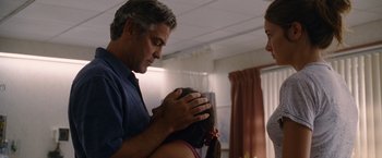 Movie still from “The Descendants” (2011), directed by Alexander Payne – A man and a woman holding a girl's head; Medium shot, Over the shoulder angle