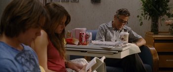 Movie still from “The Descendants” (2011), directed by Alexander Payne – A man and a woman sitting at a table reading a book; Medium shot, Over the shoulder angle