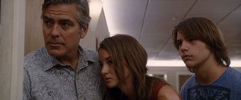 Movie still from “The Descendants” (2011), directed by Alexander Payne – A man standing next to a young woman in a room; Close Up shot, Low angle