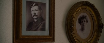 Movie still from “The Descendants” (2011), directed by Alexander Payne – An old photo of a man in a suit hanging on the wall; Extreme Close Up shot, High angle