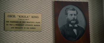 Movie still from “The Descendants” (2011), directed by Alexander Payne – An old photo of a man in a suit next to a name tag; Extreme Close Up shot, High angle