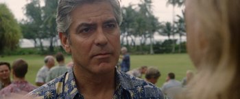 Movie still from “The Descendants” (2011), directed by Alexander Payne – A person wearing a hawaiian shirt; Close Up shot, Over the shoulder angle